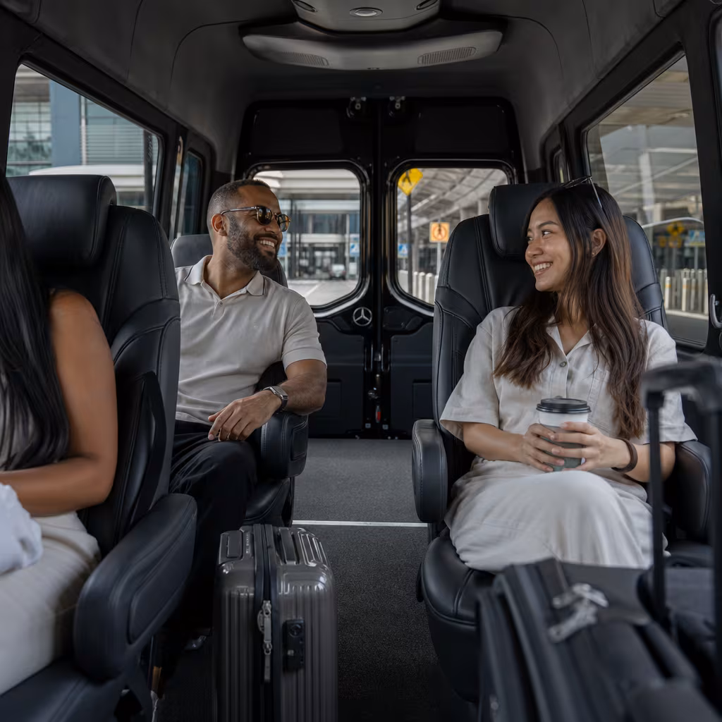 Passengers loading luggage while boarding an Baton Rouge group shuttle