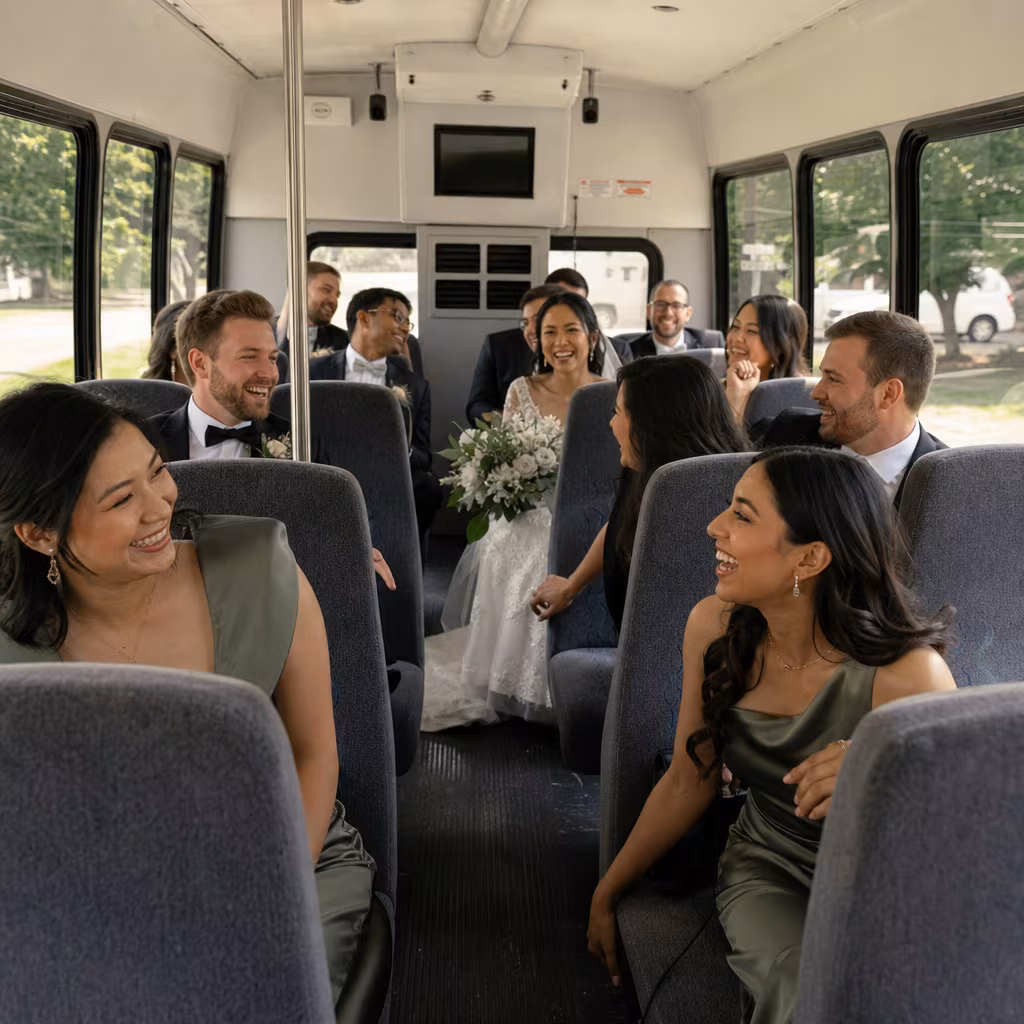 Group boarding a white charter bus for Wedding Transportation transportation in Baton Rouge